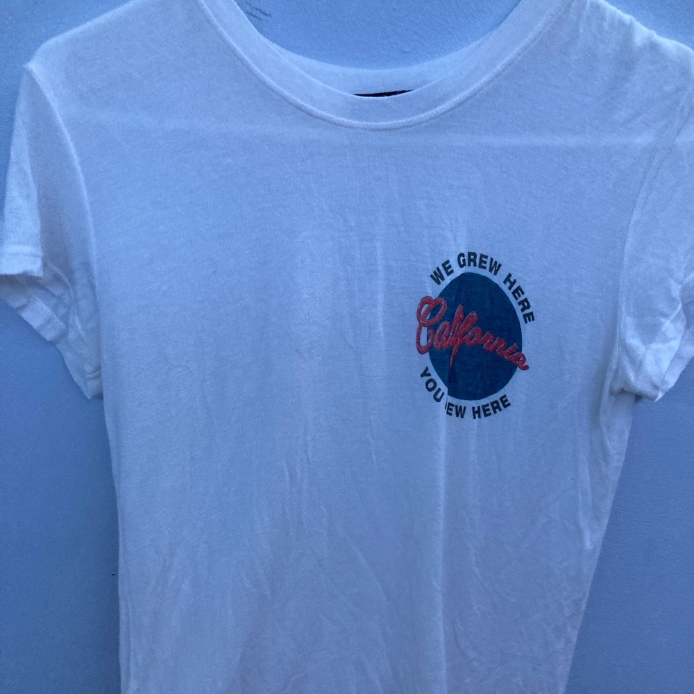 White “We Grew Here You Flew Here” tee